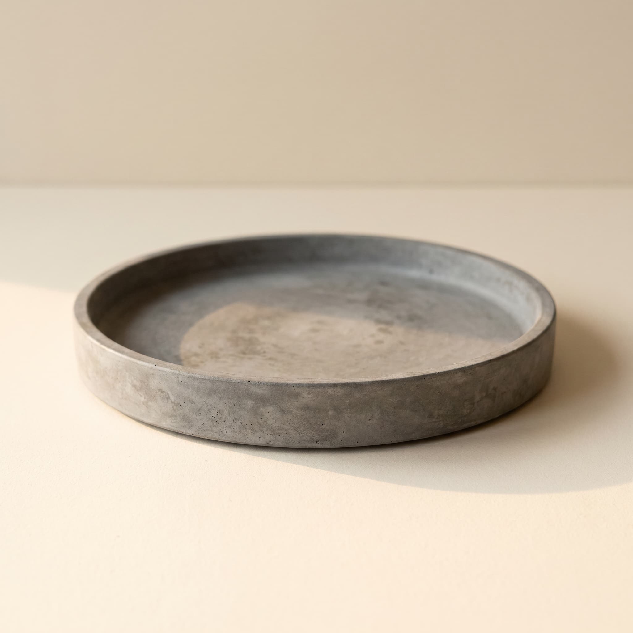 Round grey concrete saucer
