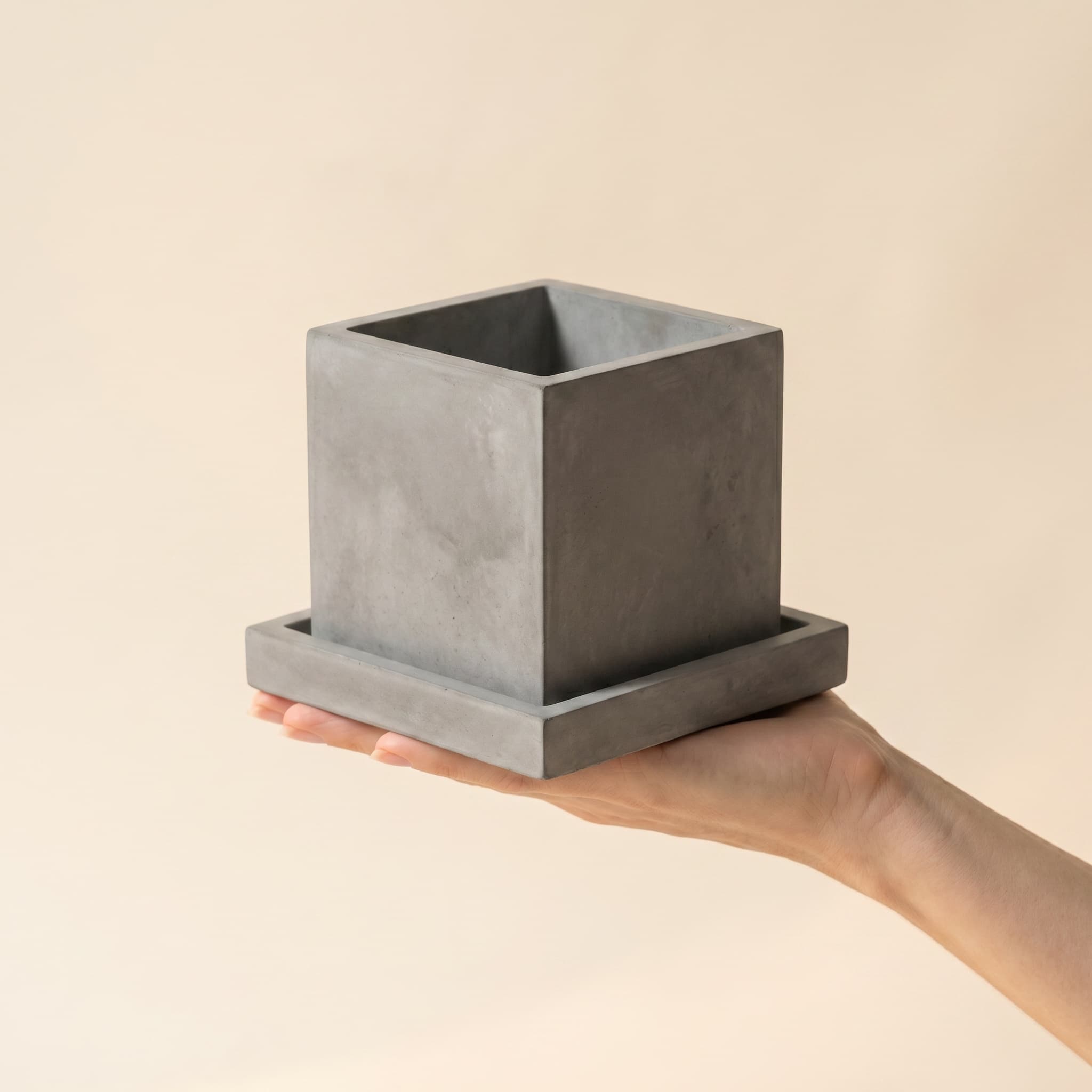 Grey cube set held in a hand