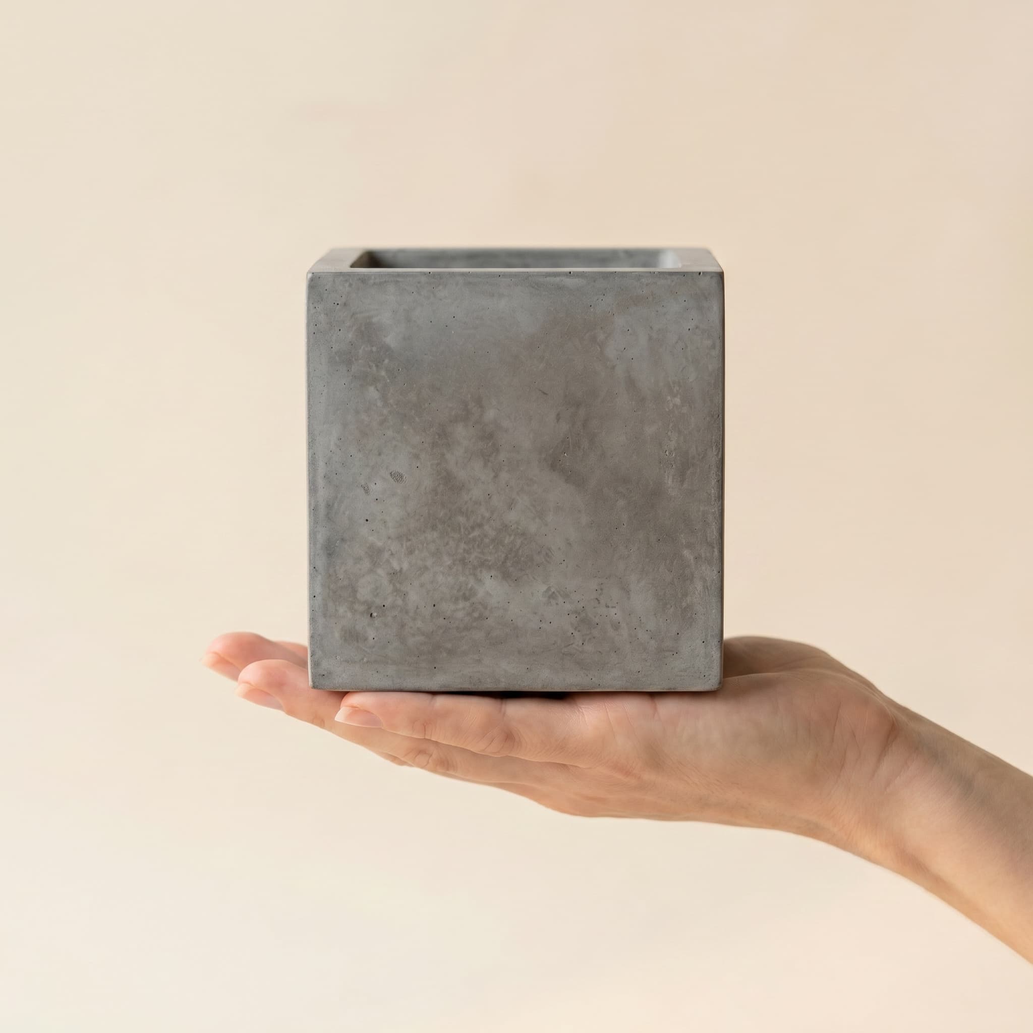Grey cube held in a hand