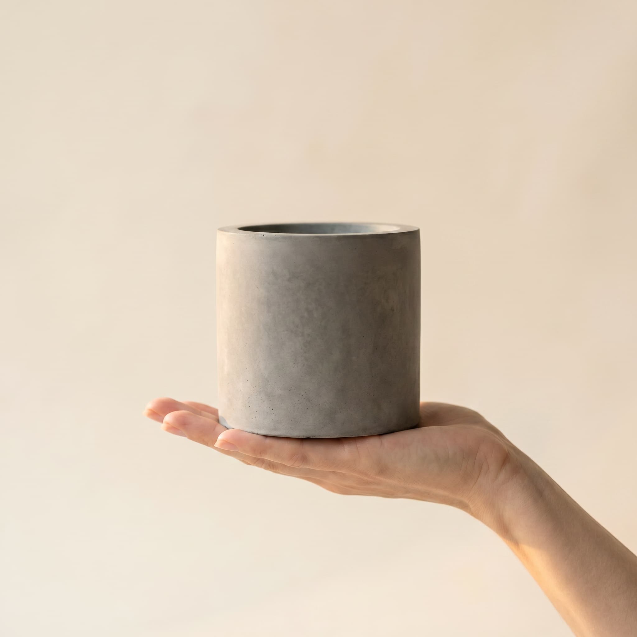 Small grey cylinder held in a hand