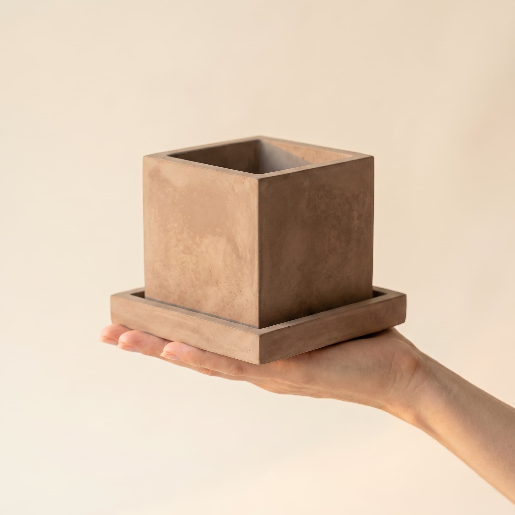Taupe cube set held in a hand