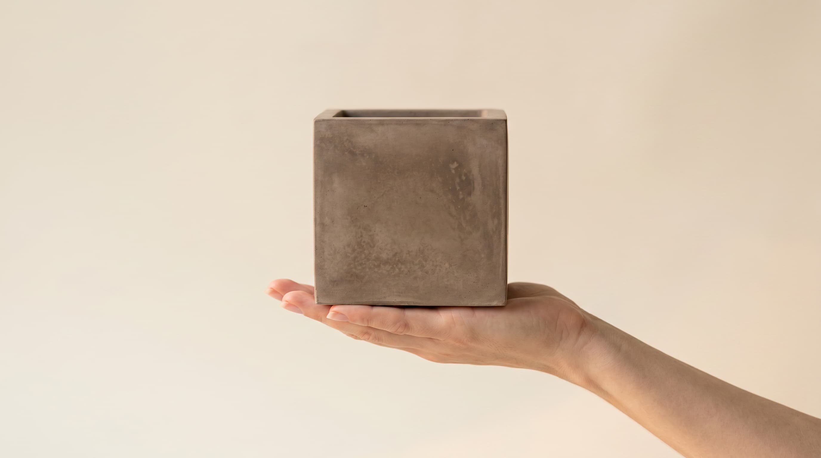 Taupe cube held in a hand
