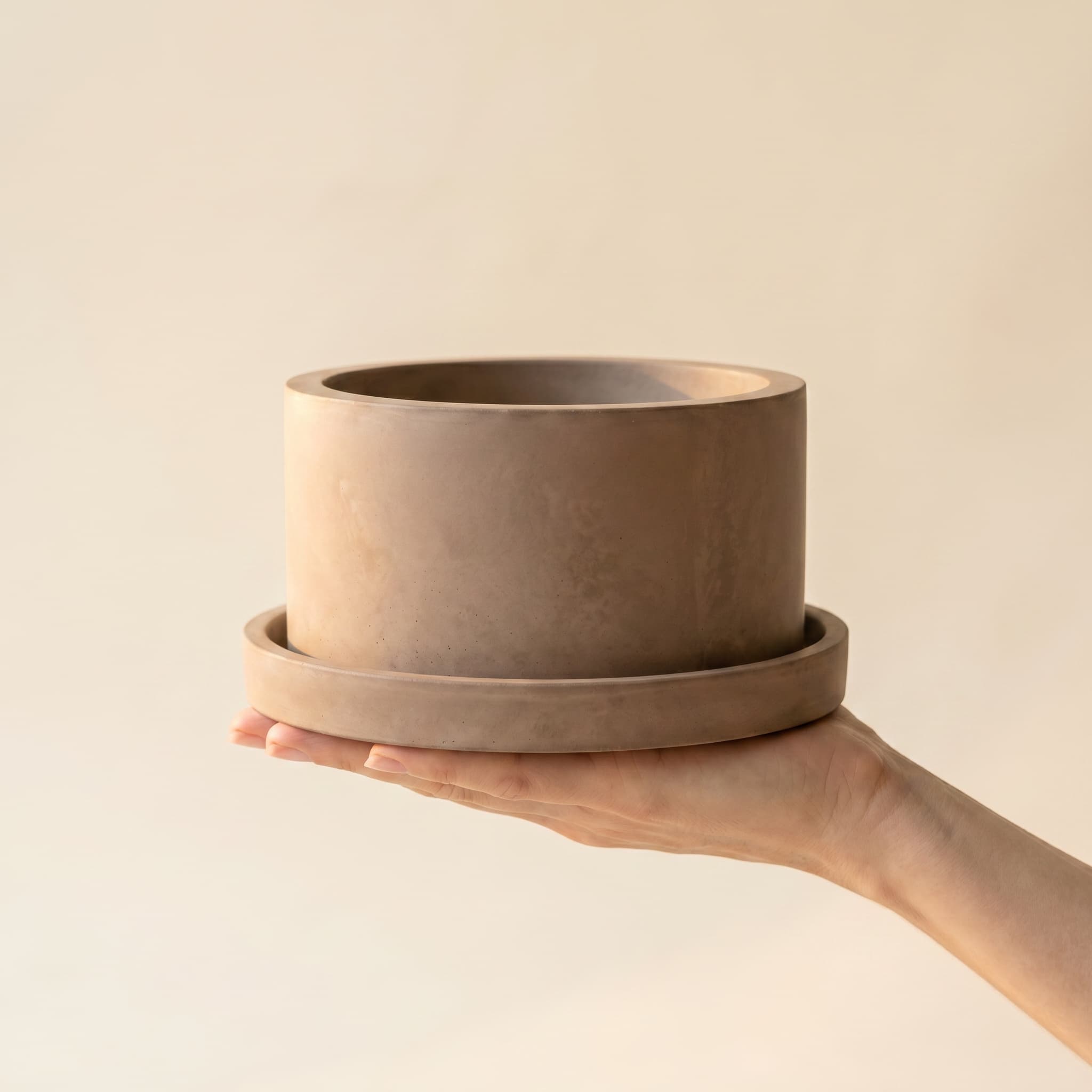 Wide taupe cylinder set held in a hand